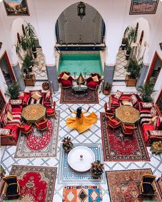 an overhead view of a living room with red couches and rugs