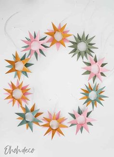 an origami star wreath made out of colored paper