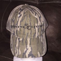 a camo hat with the words sports center on it