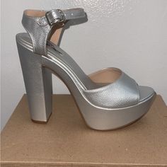 Gorgeous Silver Heels. They Are Very Comfortable And Can Be Worn For Any Ocasin. Comes With Stick On The Heel Never Have Worn Them Only Tried On When I Bought Themselves They Are A Size 6.5 Silver Heels With Stacked Heel And Ankle Strap, Silver Stacked Heel For Night Out, Silver Platform Heels With Ankle Strap, Silver High Heel Block Heels With Stacked Heel, Silver High Block Heels With Stacked Heel, Silver Block Heels With Stacked High Heel, Silver Heels With Stacked Heel And Round Toe, Silver Closed Toe Heels With Stacked Heel, Silver Synthetic Heels With Wrapped Heel