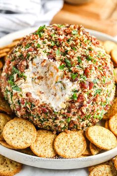 a cheese ball on top of crackers in a bowl