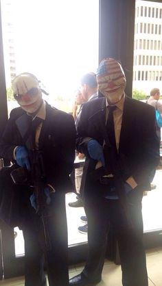 two men in suits and masks standing next to each other