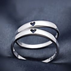 two silver rings with hearts on them