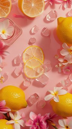 lemons, flowers and ice cubes are arranged on a pink surface with petals