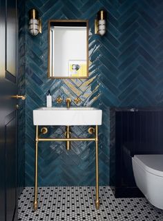 the bathroom is decorated in blue and gold