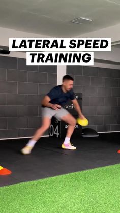 a man holding a yellow frisbee in a gym