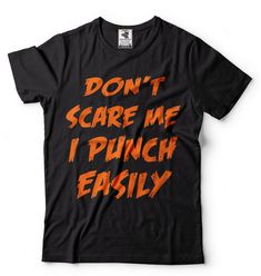 "Halloween Costume Funny T shirt Don't Scare Me I Punch Easily Funny Halloween T shirt Falls T shirt Halloween Party T shirt 100% halloween hit t-shirt.Cool and savage Halloween shirt. This ULTRA COTTON UNISEX T-shirt is made of Pre-shrunk 100% cotton, 6.1-ounce. * Seamless double-needle 7/8\" collar, Double-needle sleeves and hem, Taped neck and shoulders Our T Shirts and Hoodies are Printed by advanced technology Digital Printer on 100% Ultra Cotton tees and hoodies . We use waterbased textile Punk Halloween T-shirt With Text Print, Black Halloween T-shirt With Text Print, Black Horror T-shirt With Funny Print, Funny Halloween T-shirt For Streetwear, Funny Halloween T-shirt With Text Print, Funny Halloween Streetwear T-shirt, Funny Halloween Text Print T-shirt, Halloween Slogan T-shirt For Streetwear, Punk Halloween Text Print T-shirt