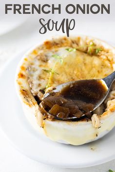 a white plate topped with an egg covered in melted cheese and mushrooms, next to a fork