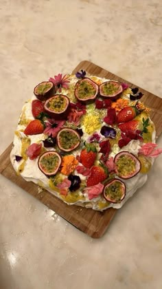 a cake with fruit on it sitting on top of a cutting board