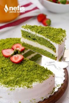 there is a green cake with strawberries on it