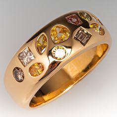 a gold ring with different colored stones on it