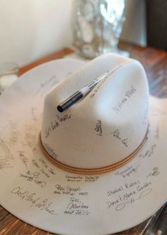 a white hat with writing on it sitting on top of a table