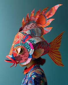 a woman wearing a colorful fish mask on her head