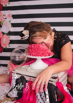 a woman in a black and white striped wall with a pink cake