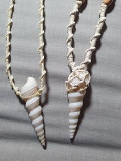 two necklaces with shells attached to them