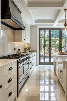 a large kitchen with white cabinets and marble counter tops, along with an open glass door leading to the outside patio