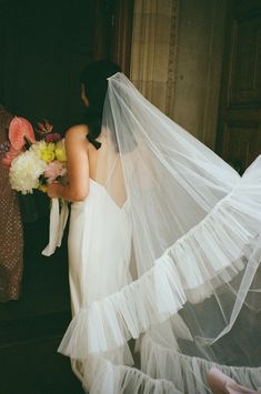 the bride is getting ready to walk down the aisle with her veil over her head