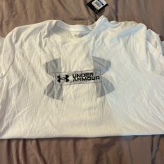 Under Armor Tee Never Worn Nwt ( Don’t Mind The Wrinkles- Was Folded In Drawer) Affordable Sporty Under Armour T-shirt, Under Armour White T-shirt With Graphic Print, White Under Armour T-shirt With Graphic Print, Casual Under Armour Tops With Logo Print, Under Armour White Crew Neck Top, White Under Armour Crew Neck Top, White Short, Under Armor, Wrinkles