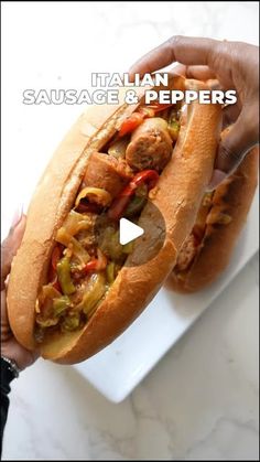 a person holding a hot dog on top of a white plate