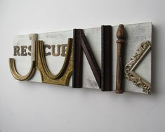 some type of sign that is hanging on the side of a wall with other letters