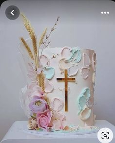 a cake decorated with flowers and a cross