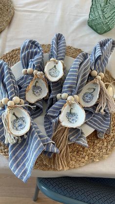 some blue and white dishes are on a wicker tray with napkins tied around them