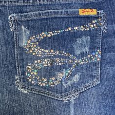 Sharp Classic Pair Of Jeans To Dress Up Or Down! Washed Once In Cold Water Due To Dust Bunnies On The Cuffs; Dried On Lowest Dryer Setting, Never Worn. Mid-Rise Medium Distressed Wash; Medium-Heavyweight Denim With A Moderate Stretch. Missing A Few Crystals, But Plenty Of Bling Remaining; Silver And Light Blue Metallic Accent Thread Details. Truest Shade Reflected In First 2 Photos. Lying Flat Measure 17" Across The Waist (18.75" When Waistband Straightened), 9.75" Rise, 31.5" Inseam, 9.75" Leg Jeans With Rhinestones, Bling Denim, Dust Bunnies, Stanley Cups, Low Rise Jeans, 2 Photos, Metallic Accents, Fern, Jeans And Boots