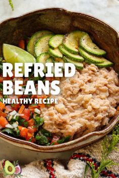 a bowl filled with beans and vegetables on top of a table