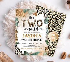 two wild birthday party cards with leopard print and gold foil on the front, surrounded by feathers