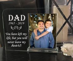 a father's day photo frame with his son and daughter on the table next to him