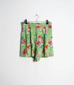 "a vintage pair of high-waisted green and pink floral pattern shorts with buttons all the way up the left side ✿ IMPORTANT INFORMATION: * excellent vintage condition * material: 100% viscose * size: small - please check exact measurements below (they're there for your benefit!) * garment care: machine washable * made in belgium ✿ MEASUREMENTS (taken while item is lying flat, some measurements will need to be doubled): * waist: 14\" (36cm) * hips: 25\" (64cm) * front rise: 14.5\" (37cm) * back ri Green Summer Pajama Shorts, Green Pajama Shorts For Summer, Fitted Floral Print Shorts, Green High-waisted Summer Pajama Shorts, Green Floral Print Shorts For Spring, Green High-waisted Summer Shorts, High Waist Green Summer Shorts, Summer Green High-waist Shorts, High Waist Green Shorts For Summer