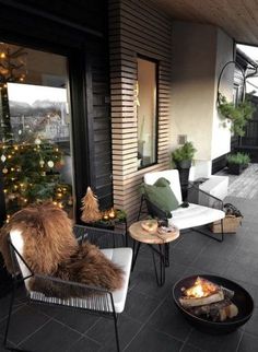 an outdoor patio with chairs, table and fire pit