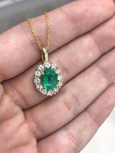 Featured here is a stunning oval cut Colombian emerald and diamond pendant made in fine 18K yellow gold. Displayed is a lustrous, grassy green with incredible transparency, accented by a simple four-prong 18K mount, allowing for the emerald to be shown in full view. Minor flaws are evident in this earth mined gem as no natural emerald is perfect. A brilliant round diamond halo surrounds the emerald and is a showstopping compliment to the center gem! This piece is ideal for everyday wear or for s Emerald And Diamond Pendant, Timeless Oval May Birthstone Jewelry, Classic Emerald And Diamond Necklace, Timeless Oval Emerald Jewelry, Classic Hallmarked Emerald Necklace With Diamonds, Classic Hallmarked Emerald And Diamond Necklace, Classic Hallmarked Diamond Emerald Necklace, Classic Round Emerald Necklace With Diamond Accents, Classic Emerald Necklace With Diamond Accents