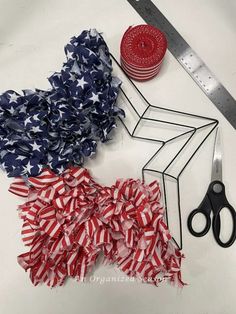 american flag ruffles, scissors and measuring tape laid out on a white surface