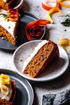 two slices of carrot cake on black plates