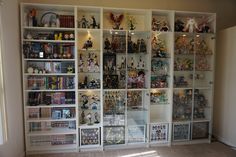 a room filled with lots of different types of action figures and figurines on shelves