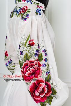 This white embroidered dress has a flared silhouette, floor length, and will be worthy of appearing at any event. A feature of this model is the shirt style of the upper part of the dress hem. this boho dress has a button closure on front and stand-up collar. A long cambric dress with wide sleeves and a flared skirt with a flounce is decorated with incredibly beautiful embroidery which embodies the sophisticated femininity and romantic mood. The bottom of the elegant dress is duplicated with a t White Floral Embroidery Floor-length Dress, White Floor-length Dress With Floral Embroidery, White Embroidered Floor-length Dress, White Floor-length Dress With Intricate Embroidery, White Floor-length Embroidered Dress With Intricate Detail, White Floor-length Embroidered Dress, White Floor-length Maxi Dress With Floral Embroidery, Traditional White Maxi Dress With Floral Embroidery, White Floor-length Embroidered Dress For Spring