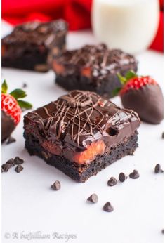 chocolate brownies with strawberries and milk on white surface