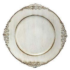 a white and gold plate with an ornate design on the rim, against a white background