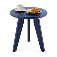 a blue table with a plate of food on it next to a cup of coffee