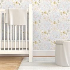 a white crib in front of a wallpapered nursery