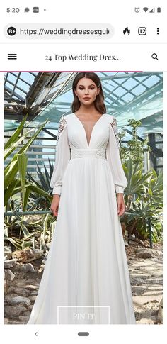 a woman wearing a white dress standing in front of some plants