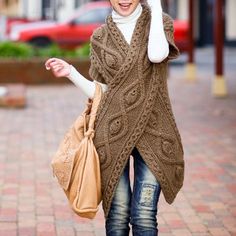 a woman is walking down the street talking on her cell phone and holding a purse