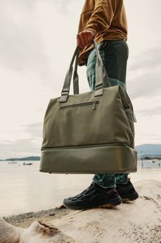 Introducing the mini edition of our OG weekender. This bag is a minimalist’s dream and is perfect as a personal item (+ just as good for an overnight trip, or even a weekend away). Take the stress out of packing with a wide, easy-access opening, a built-in padded laptop sleeve, and a separate bottom compartment (perfect for shoes, toiletries, or dirty laundry). Ready to go? Simply slide our trolley passthrough pocket over your suitcase handles, and you’re off! *Actual colors may vary. Sporty Weekender Bag With Zipper Pocket For Travel, Sporty Weekender Bag For Travel, Practical Weekender Bag For Weekend Trips, Versatile Weekender Bag With Zipper Pocket, Versatile Travel Bag For Outdoor, Versatile Outdoor Travel Bag With Zipper, Functional Weekender Bag With Zipper Pocket, Versatile Outdoor Travel Bag With Zipper Closure, Functional Weekender Bag With Zipper Pocket For Travel