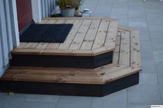 the steps are made out of wood and have black rugs on them