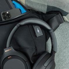 the headphones are laying on top of the bag