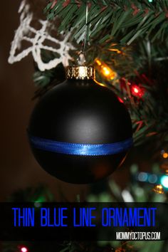 an ornament hanging from a christmas tree with the words thin blue line ornament on it