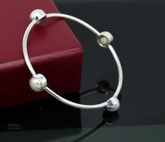 These bangles are amazing pearls and it available in all sizes. best handmade 925 Sterling silver awesome white pearl bangle bracelet, excellent gifting tribal ethnic bangle jewellery for gifting from India. Metal-925 Sterling Silver. Item type- Bangle/Bracelet. Width-2.5mm (stone part width-10mm) Size-2-2 to 2-10(select your size.) Weight- 15 to 18 Grams. Stamped-925. Finish-Oxidized. Quantity-Single kada. Makes excellent gifting for birthdays, mother's day, wedding, anniversary. Handmade Round White Gold Bangle, Wedding Sterling Silver Round Pearl Bracelet, Sterling Silver Bangle Pearl Bracelet As Gift, Handmade Sterling Silver Bracelet For Wedding, Handmade Sterling Silver Round Bracelet For Wedding, Sterling Silver Pearl Bangle Bracelet Gift, Sterling Silver Wedding Bangle, White Pearl Round Bangle, Handmade Pearl Bracelet For Anniversary