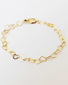 "🤍 14k Gold-filled Heart Chain Bracelet 🤍 Non-Tarnish 🤍 Comes ready to gift 🤍Perfect mother/daughter gift, baby shower or first birthday gift, ect  🤍It has an extra 1/2 of extended chain  🤍Water resistant  ⚜️ Gold filled products differ from gold plated.  Here are the major differences. Gold Filled: ✔️Affordable cost and great quality  ✔️Great for everyday wear ✔️Leave it on even when showering, water resistant! ✔️Tarnish resistant  ✔️Hypoallergenic  ✔️Gold layer is thicker than gold plated and bonded to base metal rather than painted on! Gold Plated ‼️OUR JEWELRY IS NOT GOLD PLATED‼️ Likely to tarnish fast Not always safe for sensitive skin  Not great for everyday wear Not water resistant  Thinner layer of gold 🤍Sizing: 4\" Newborn-6 months 4.5\" 6-12 months  5\" 1-2 years (3 years Gold Heart-shaped Name Bracelet For Everyday, Everyday Gold Heart Name Bracelet, Hypoallergenic Heart-shaped Name Bracelet For Mother's Day, Mother's Day Heart Bracelet With Lobster Clasp, Mother's Day Gift Heart Bracelet With Lobster Clasp, Mother's Day Heart-shaped Hypoallergenic Name Bracelet, Gold Hypoallergenic Heart Bracelet As Gift, 14k Gold Charm Bracelet For Valentine's Day Gift, 14k Gold Bracelet With Extender As A Gift