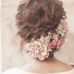 a woman with flowers in her hair wearing a white dress and looking off into the distance